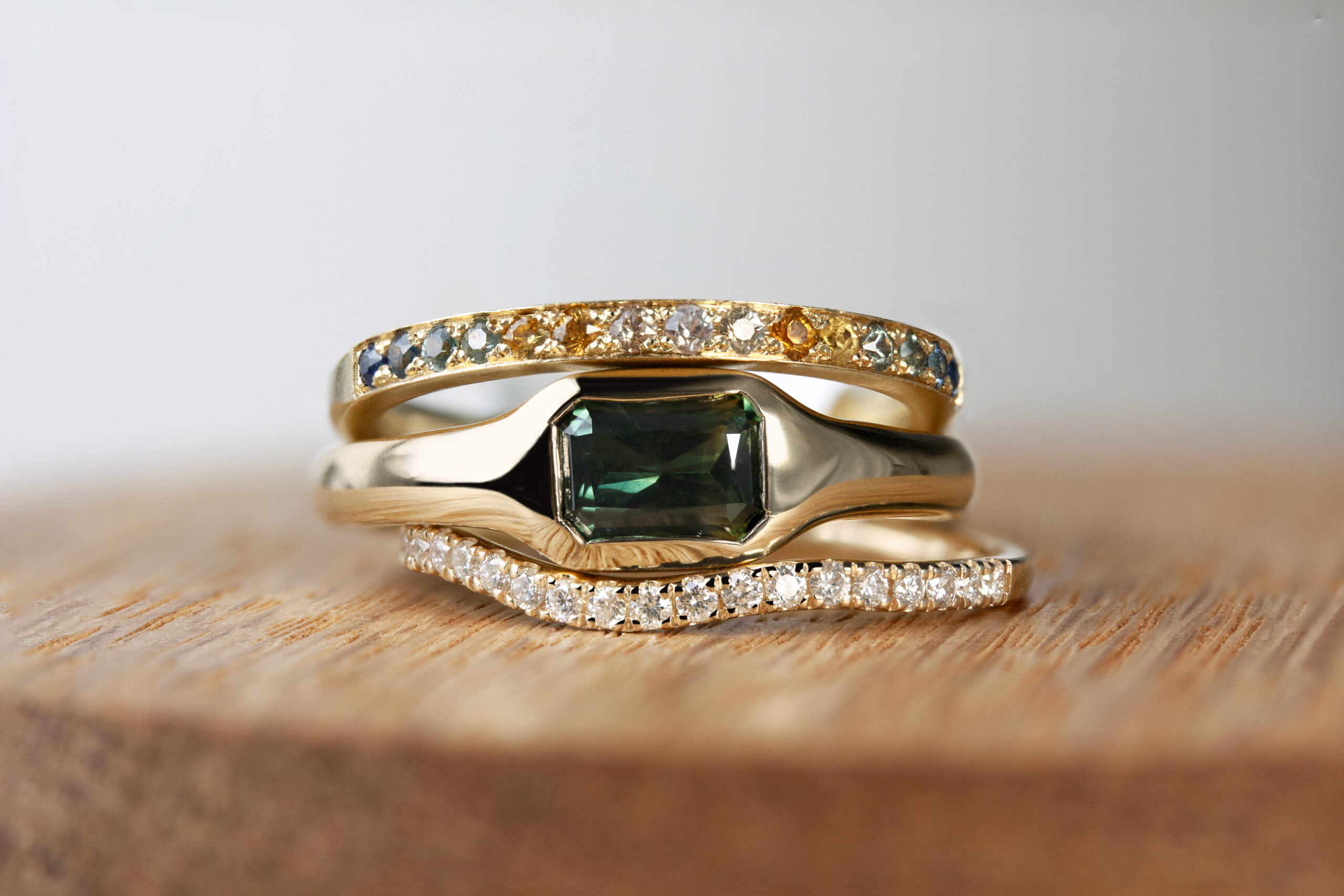 Gold signet ring with bands by Philadelphia's Emily Chelsea Jewelry with soft curves and a flush-set center stone.