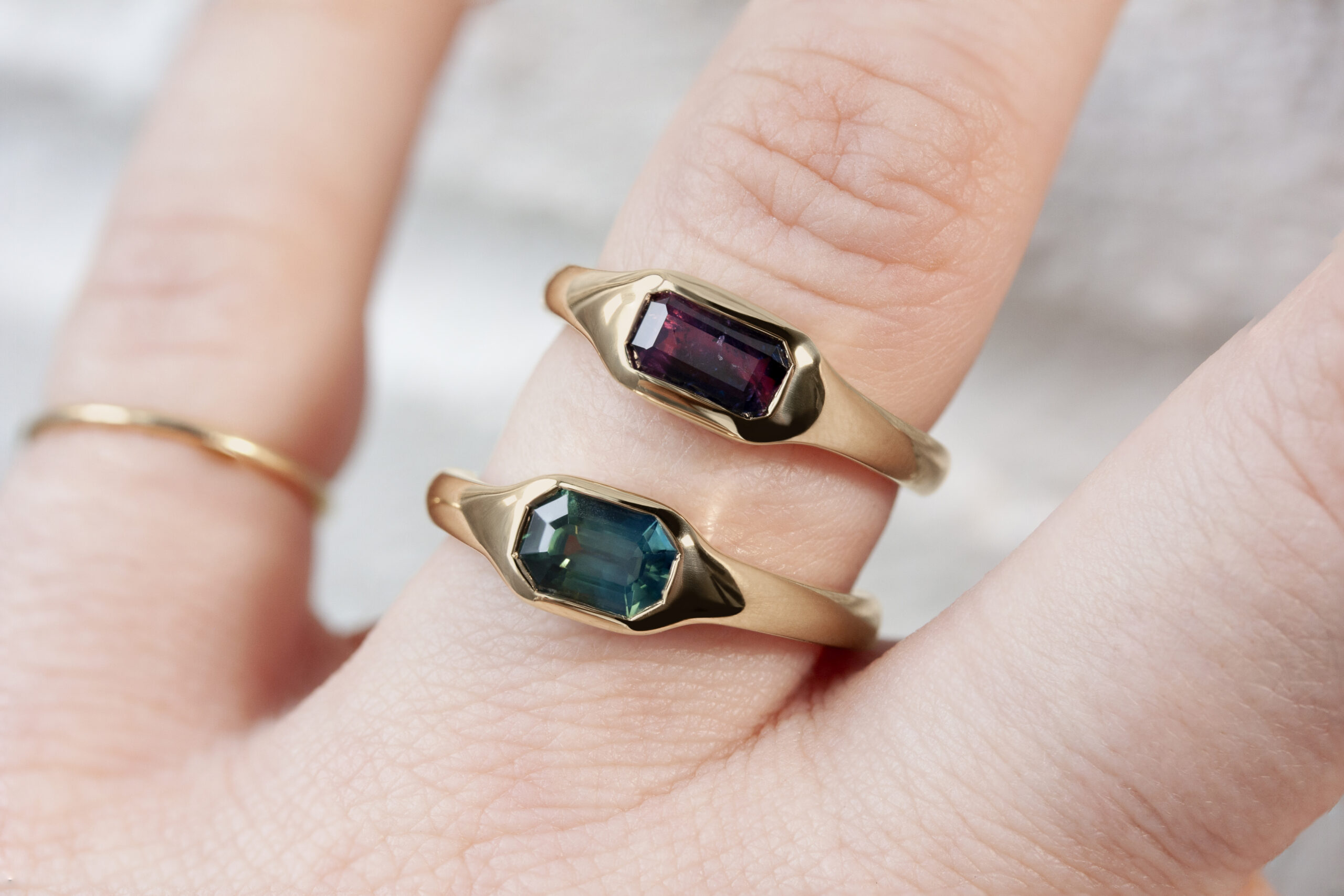 Classic gold signet rings by Philadelphia's Emily Chelsea Jewelry, featuring soft curves and a flush-set center stone.