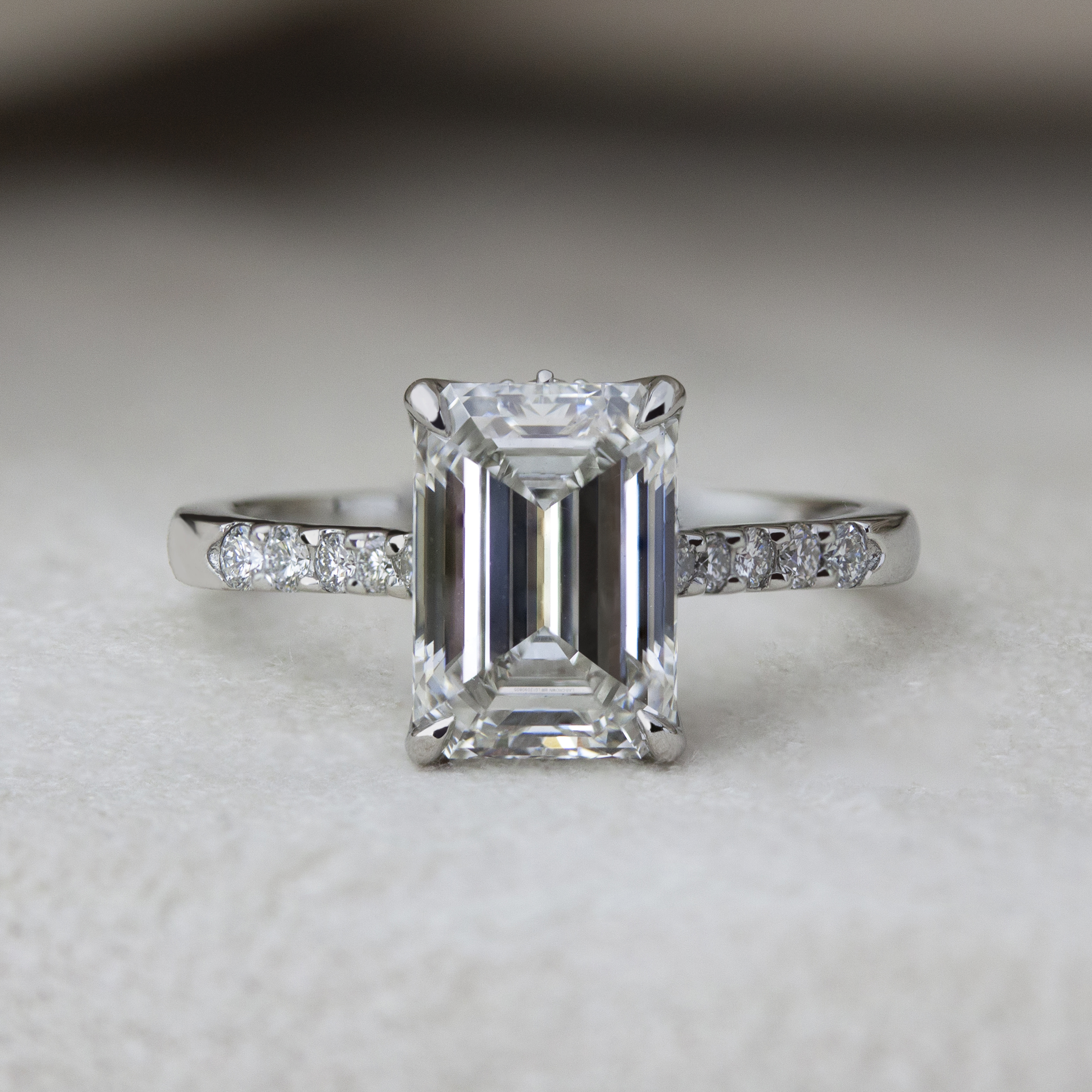 Custom ring by Philadelphia's Emily Chelsea Jewelry with hidden flower prongs, accent diamonds, and a tapered 2mm band.