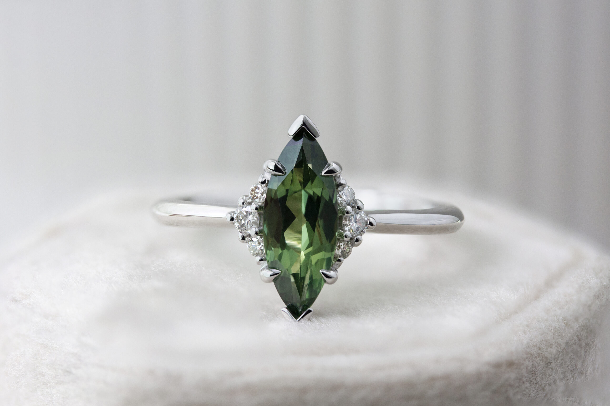 Cloud Ring by Philadelphia local jeweler Emily Chelsea Jewelry, featuring reclaimed diamonds, a 1.8mm band, and understated sparkle to highlight your emerald center stone.