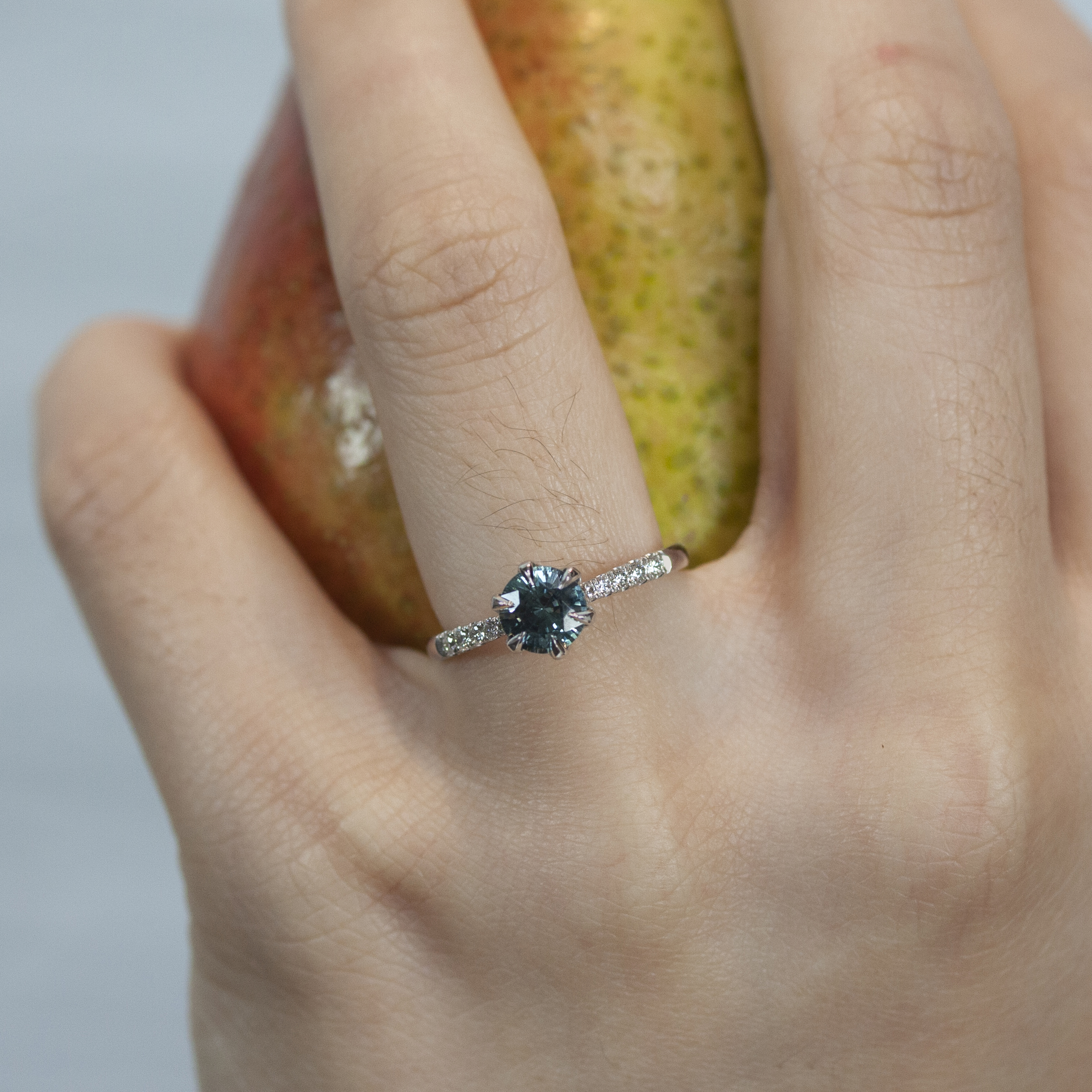 Custom ring by Philadelphia's Emily Chelsea Jewelry with hidden floral prongs, accent diamonds, and a tapered 2mm band.