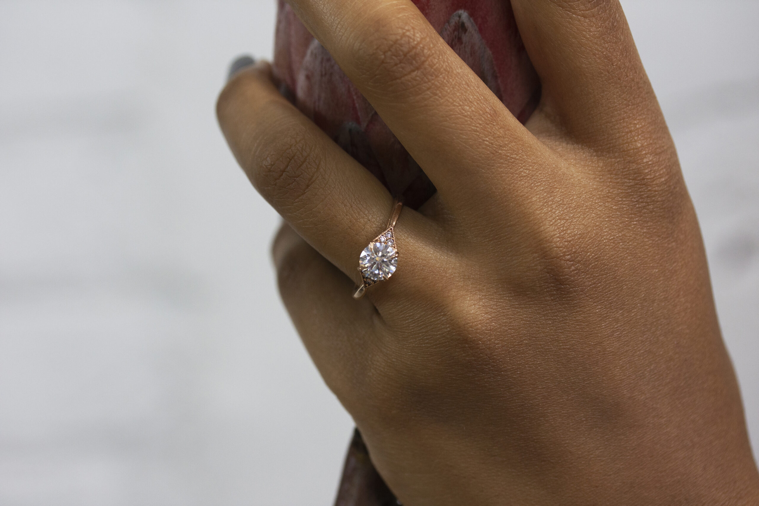 Custom June Ring by Philadelphia's Emily Chelsea Jewelry, featuring a timeless geometric design, reclaimed white diamonds, and a classic white center stone.