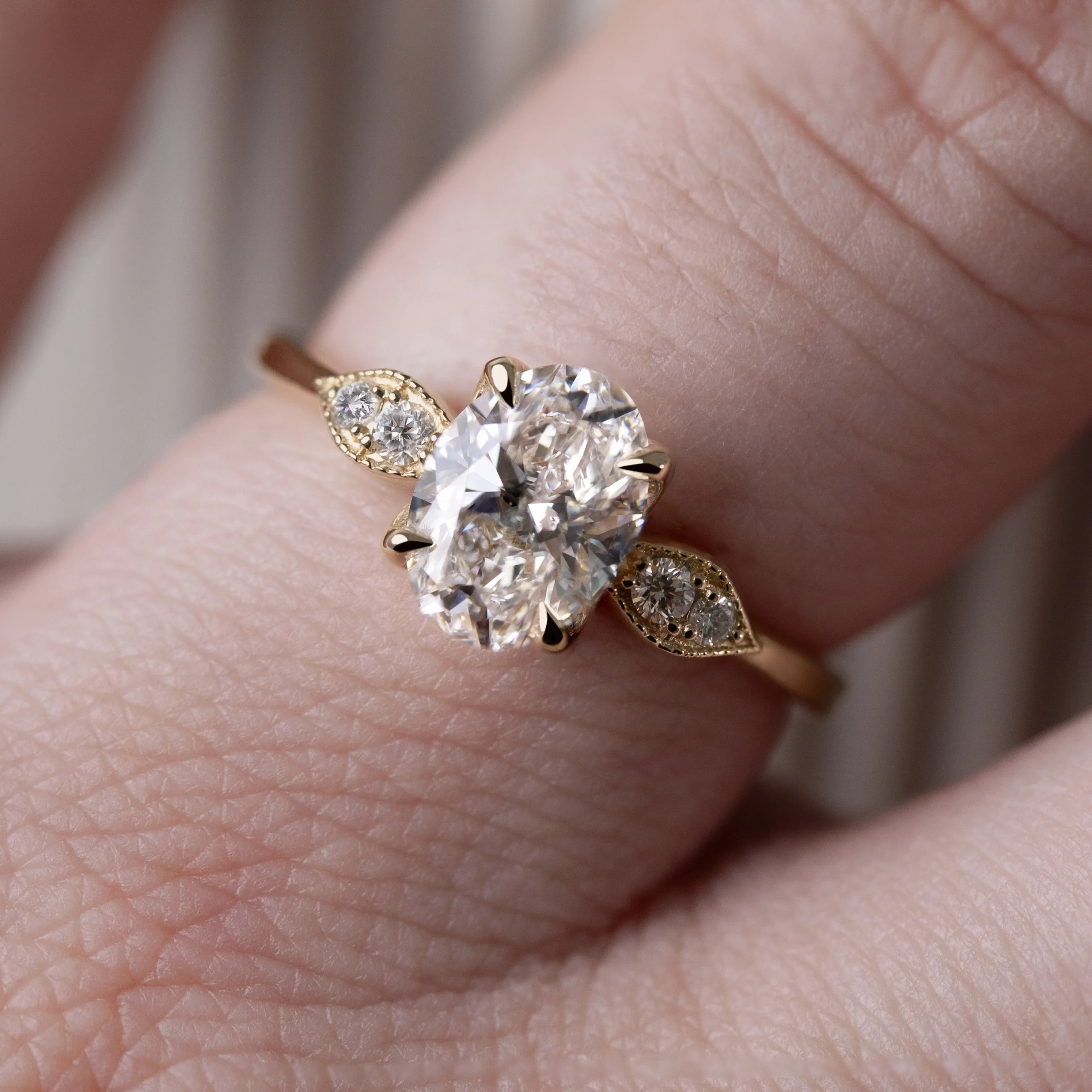 The Gardenia Ring by Philadelphia's Emily Chelsea Jewelry, a custom-designed piece with floral details, milgrain texture, and 0.08ctw reclaimed diamonds on a 2mm band.