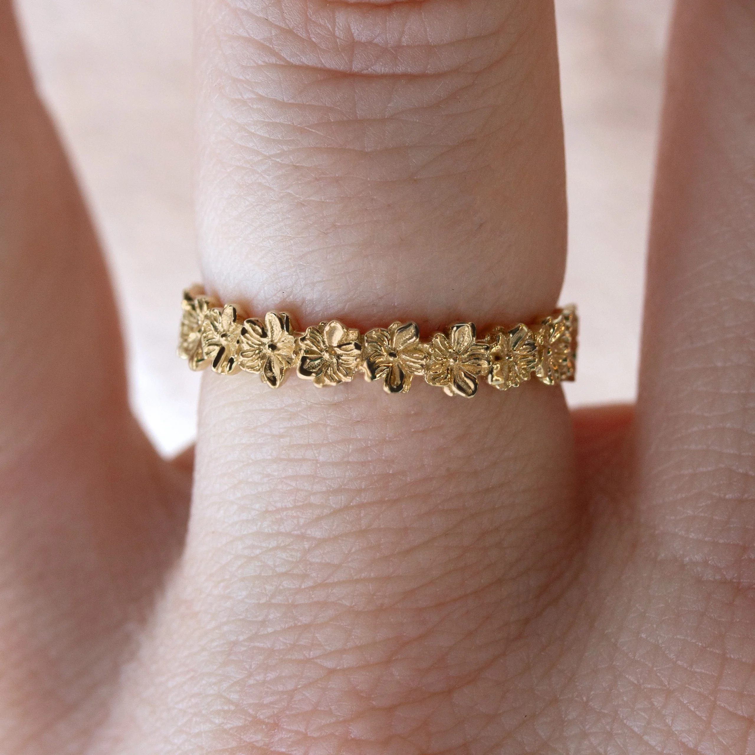 Custom-designed Violet band ring from Philadelphia's Emily Chelsea Jewelry featuring a complete ring of violets on a 3.4mm wide band.
