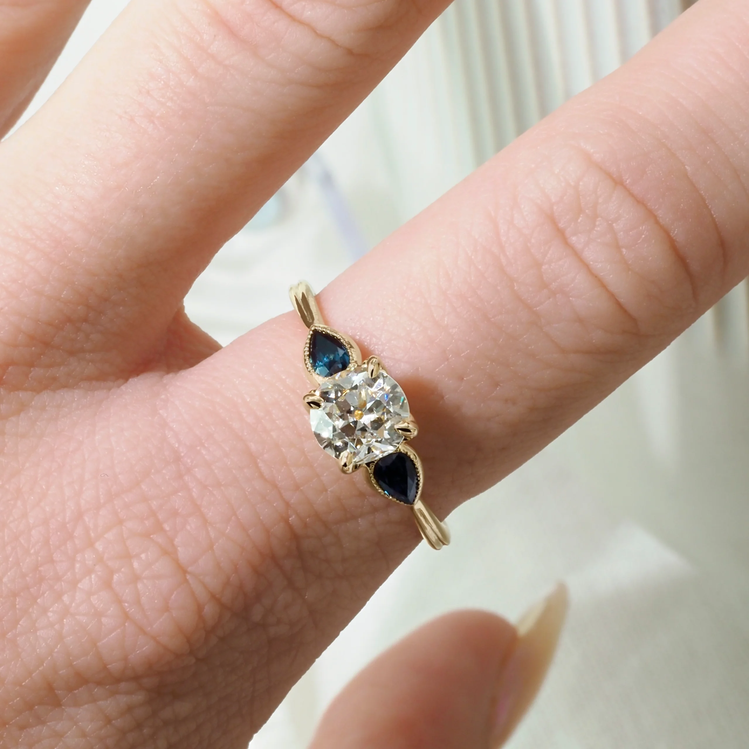 The Gardenia Ring by Philadelphia local jeweler Emily Chelsea Jewelry, a custom-designed diamond ring with floral details, petal prongs, and milgrain texture.