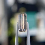 1.35ct unheated emerald-cut blue and orangish pink sapphire from Winza, Tanzania. Rare color-zoned gem. Emily Chelsea Custom Jeweler in Philadelphia.