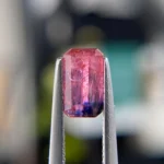 1.29ct unheated emerald-cut reddish pink and purple Winza sapphire. Rare color-zoned gem. Emily Chelsea Custom Jeweler in Philadelphia.
