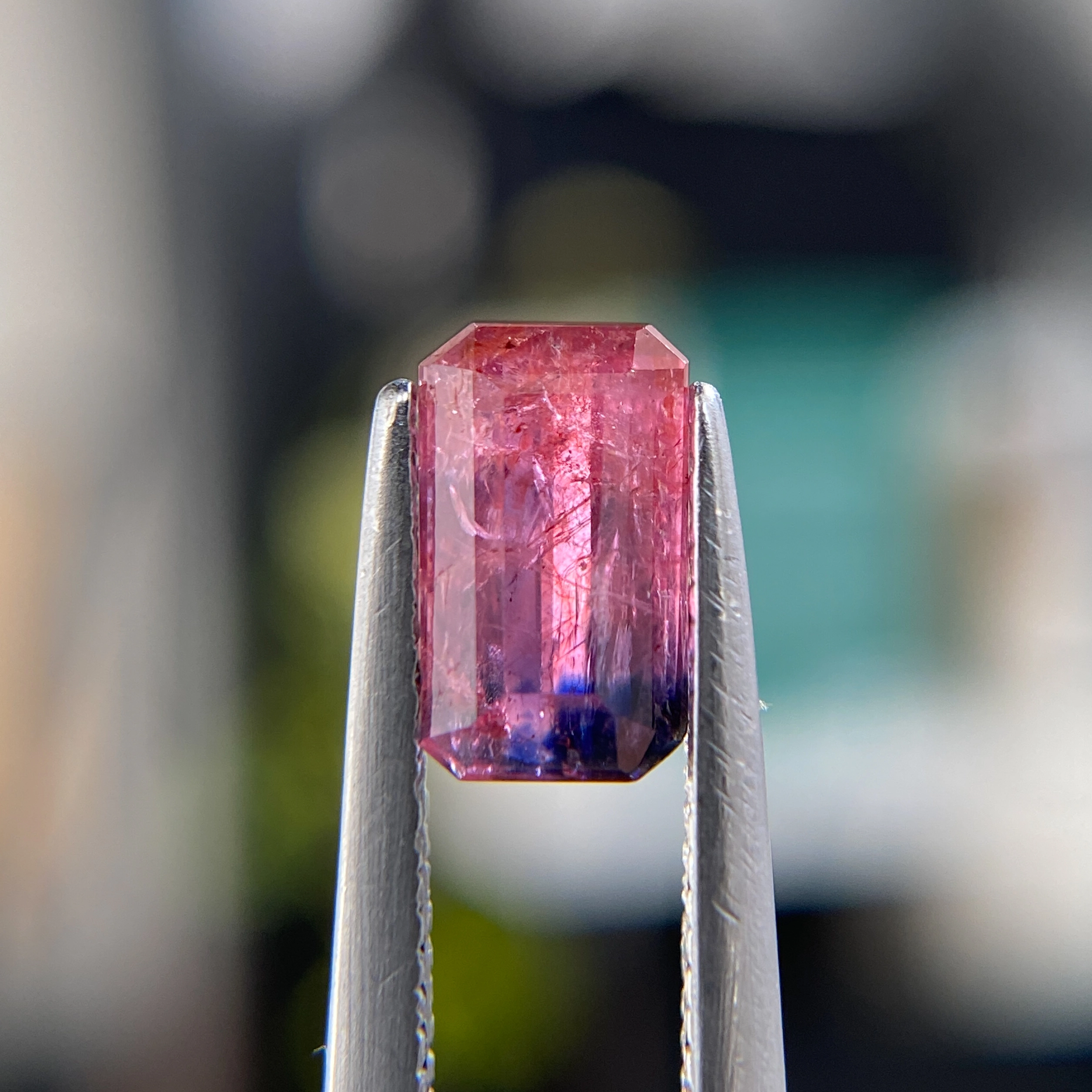 1.29ct unheated emerald-cut reddish pink and purple Winza sapphire. Rare color-zoned gem. Emily Chelsea Custom Jeweler in Philadelphia.