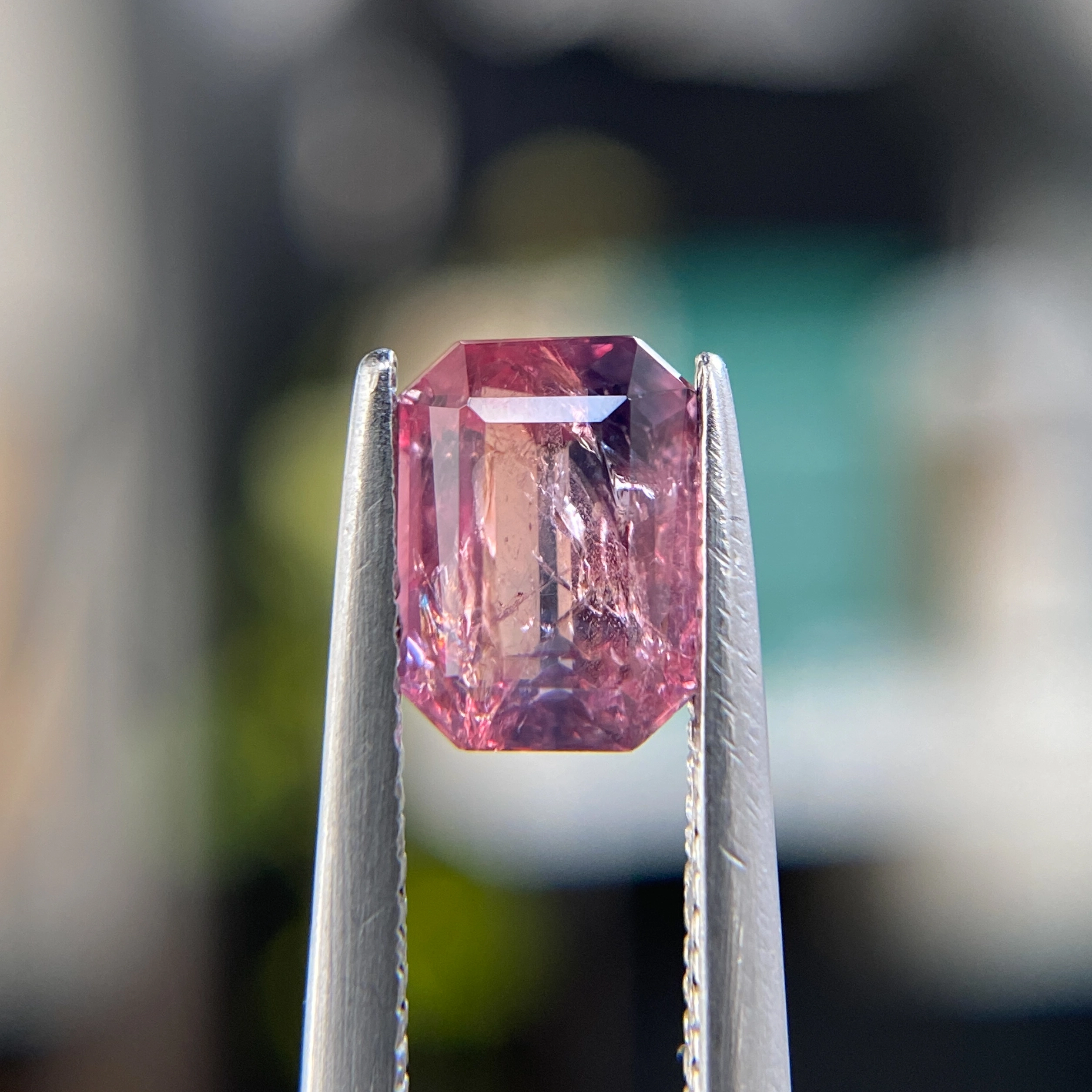 1.46ct unheated emerald-cut orange, pink, and purple Winza sapphire, 7.04mm x 5.18mm. Rare color-zoned gem. Emily Chelsea Custom Jeweler in Philadelphia.