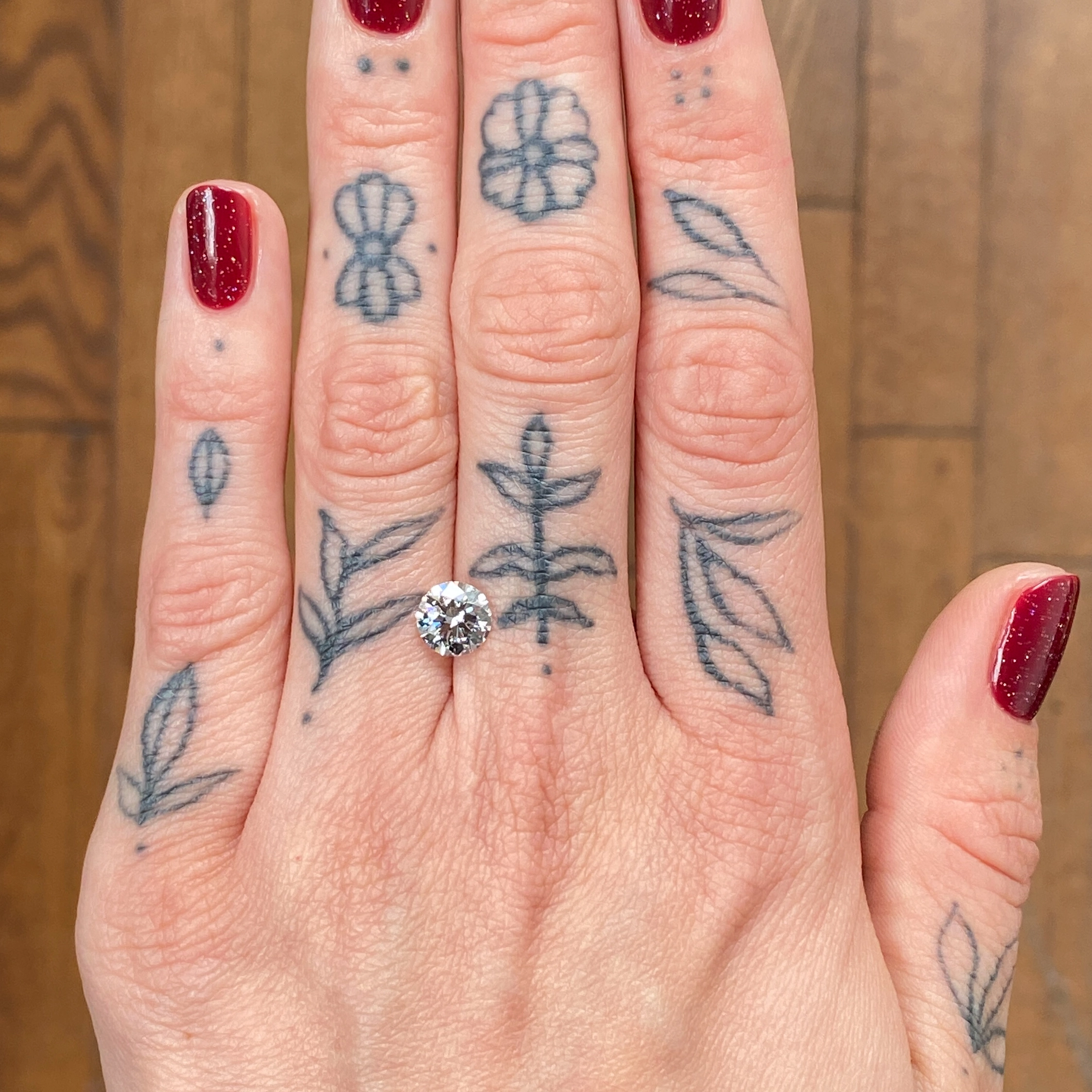 Woman's hand showing a diamond - Emily Chelsea Jewelers