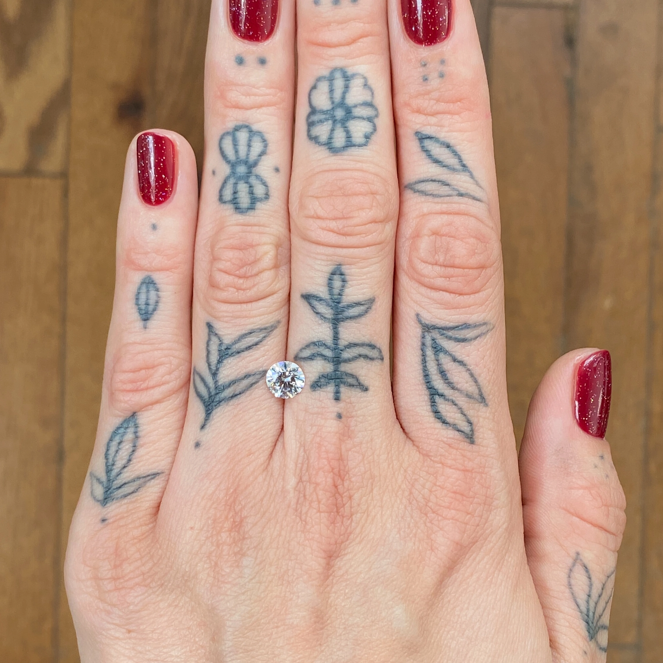 Woman's hand showing a diamond - Emily Chelsea Jewelers