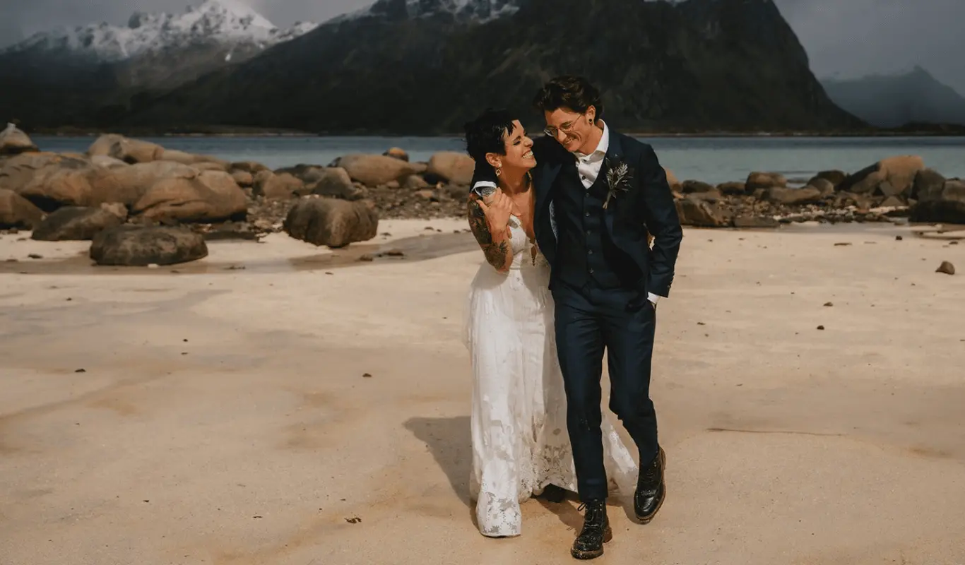 A couple embrace happily at a beach - Our custom design process