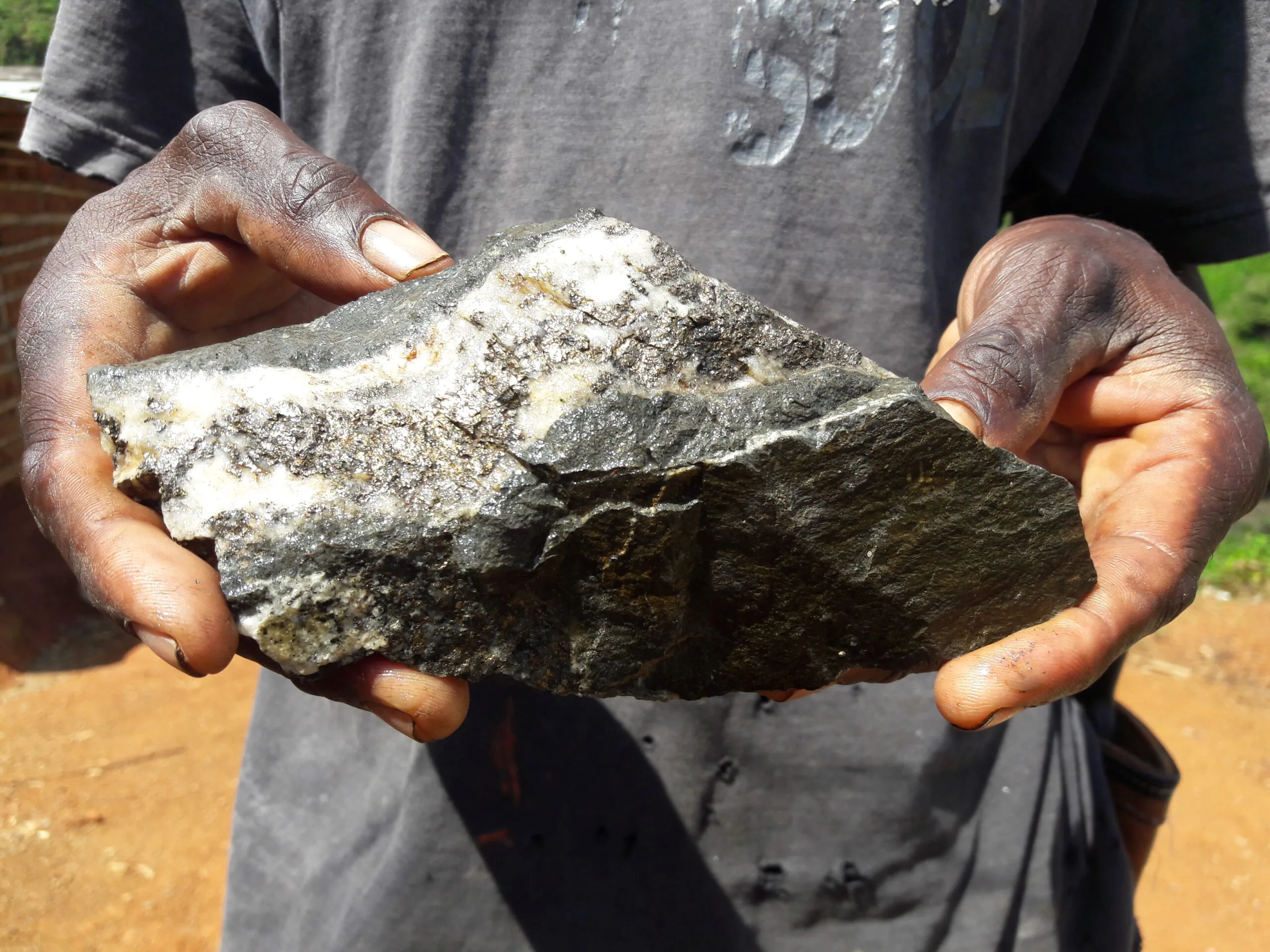 Man holds a large stone - Emily Chelsea Values