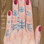 Woman's hand showing diamonds in .75ct, 1.0ct, 1.5ct, and 2.0ct for Emily Chelsea Jewelers.