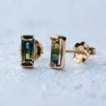 Custom bicolor sapphire stud earrings from Philadelphia's Emily Chelsea Jewelry, featuring a blue-to-yellow gradient in a bar setting. Made to order.