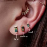 Geometric stud earrings by Philadelphia’s Emily Chelsea Jewelry, featuring Australian baguette bicolor sapphires in a bar-set design.