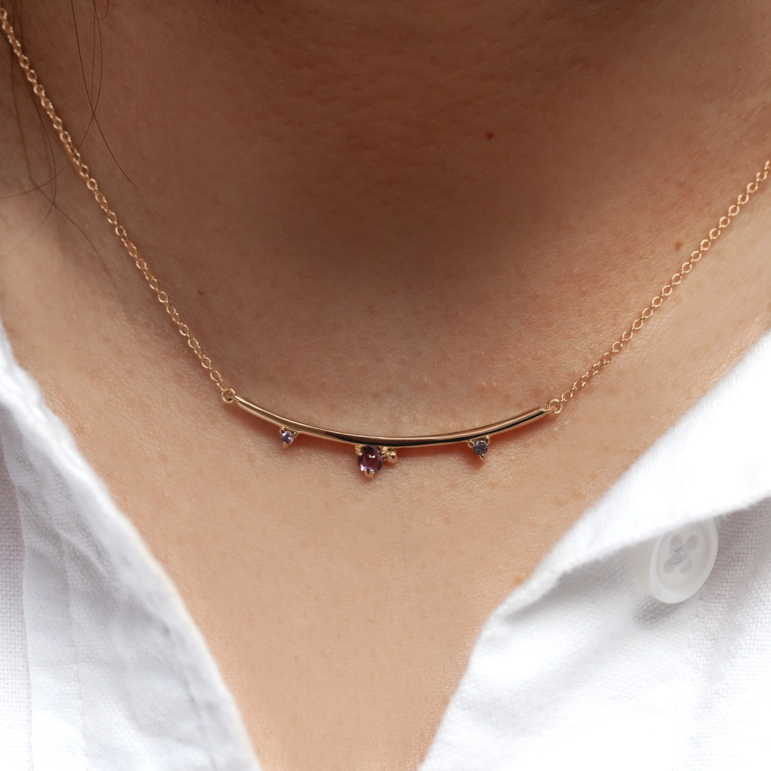 Arc Necklace by Philadelphia’s Emily Chelsea Jewelry, featuring Uruguayan amethyst, Tanzanian lavender spinel, and a delicate curved design.