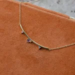 Arc Necklace by Philadelphia’s Emily Chelsea Jewelry, featuring Uruguayan amethyst, Tanzanian lavender spinel, and a gracefully curved design.