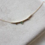 Arc Necklace by Philadelphia’s Emily Chelsea Jewelry, featuring Indian moss agate, Nigerian green tourmaline, and a gracefully curved design.