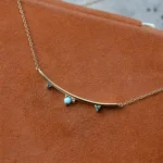 Arc Necklace by Philadelphia’s Emily Chelsea Jewelry, featuring Arizonian turquoise, Nigerian teal tourmaline, and a gracefully curved design.