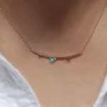 Arc Necklace by Philadelphia’s Emily Chelsea Jewelry, featuring Arizonian turquoise, Nigerian teal tourmaline, and a gracefully curved design.