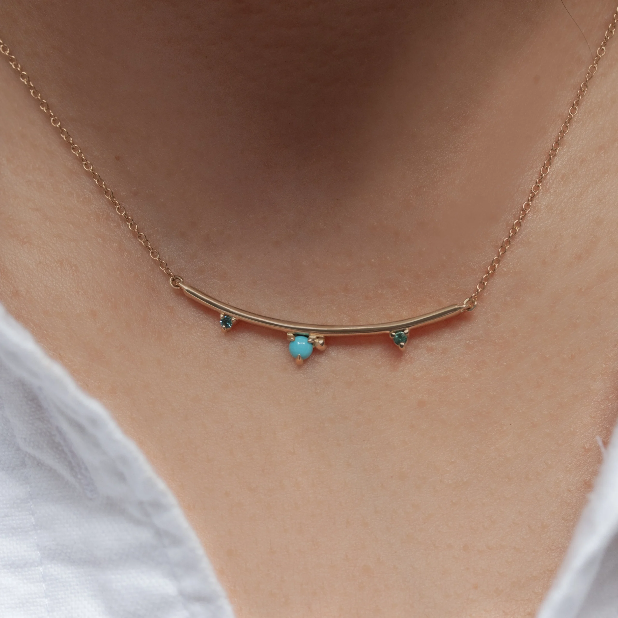 Arc Necklace by Philadelphia’s Emily Chelsea Jewelry, featuring Arizonian turquoise, Nigerian teal tourmaline, and a gracefully curved design.