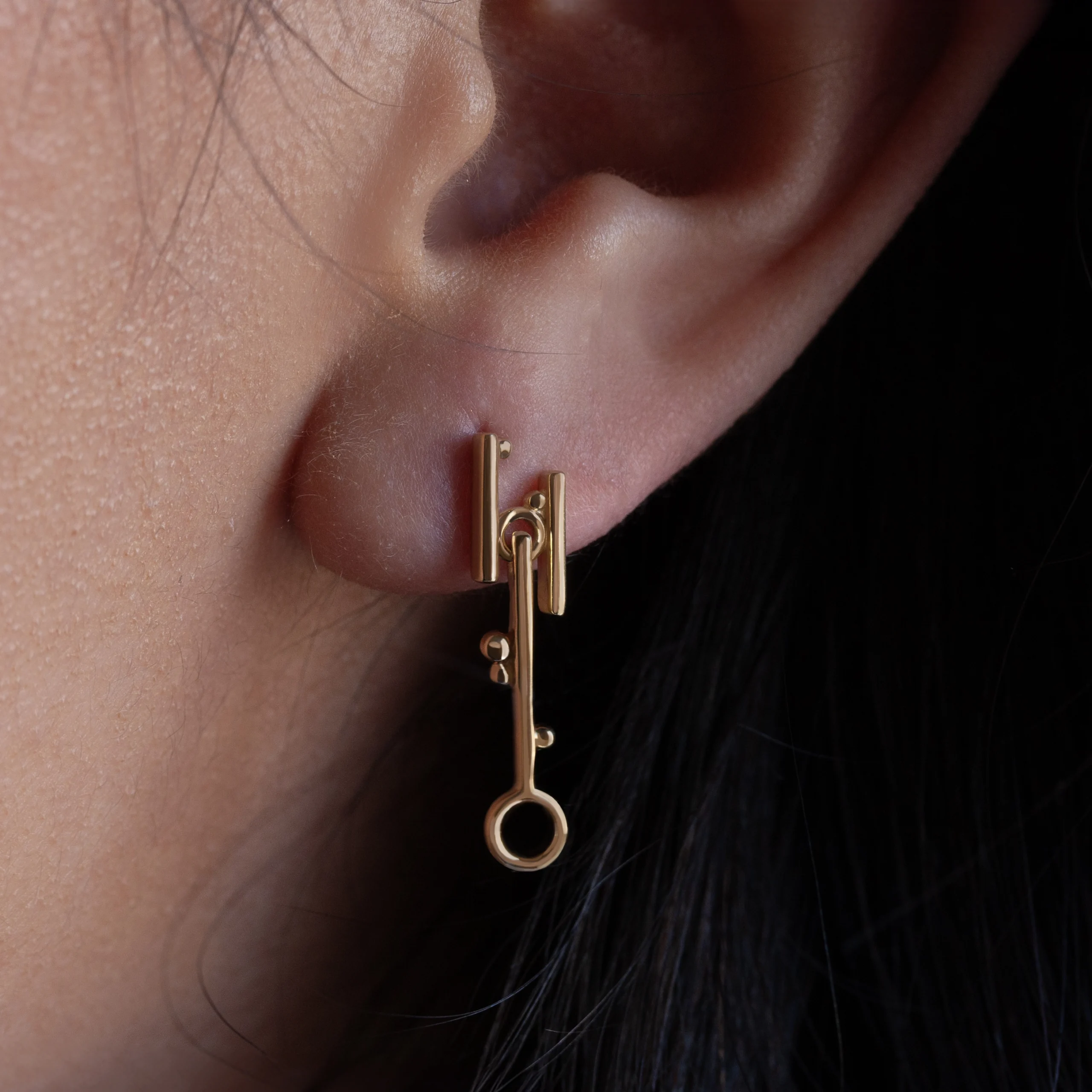 Break Through Dangle Earrings by Philadelphia’s Emily Chelsea Jewelry, featuring a cross-metal design symbolizing resilience and forward movement.