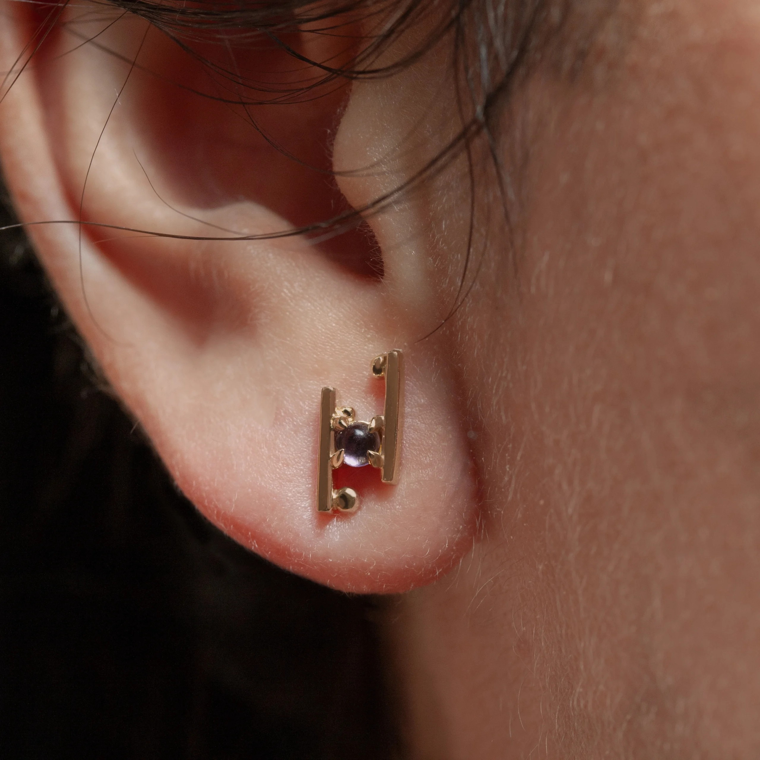 Hand in Hand Stud Earrings by Philadelphia’s Emily Chelsea Jewelry, featuring Uruguayan amethyst cabochons set between sleek metal bars.