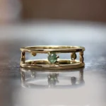 Pinnacle Band by Emily Chelsea Jewelry, a custom-designed ring featuring a 3mm Indian moss agate cabochon, symbolizing milestones and movement forward.