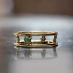 Pinnacle Band by Emily Chelsea Jewelry, a custom-designed ring featuring a 3mm Indian moss agate cabochon, symbolizing milestones and movement forward.