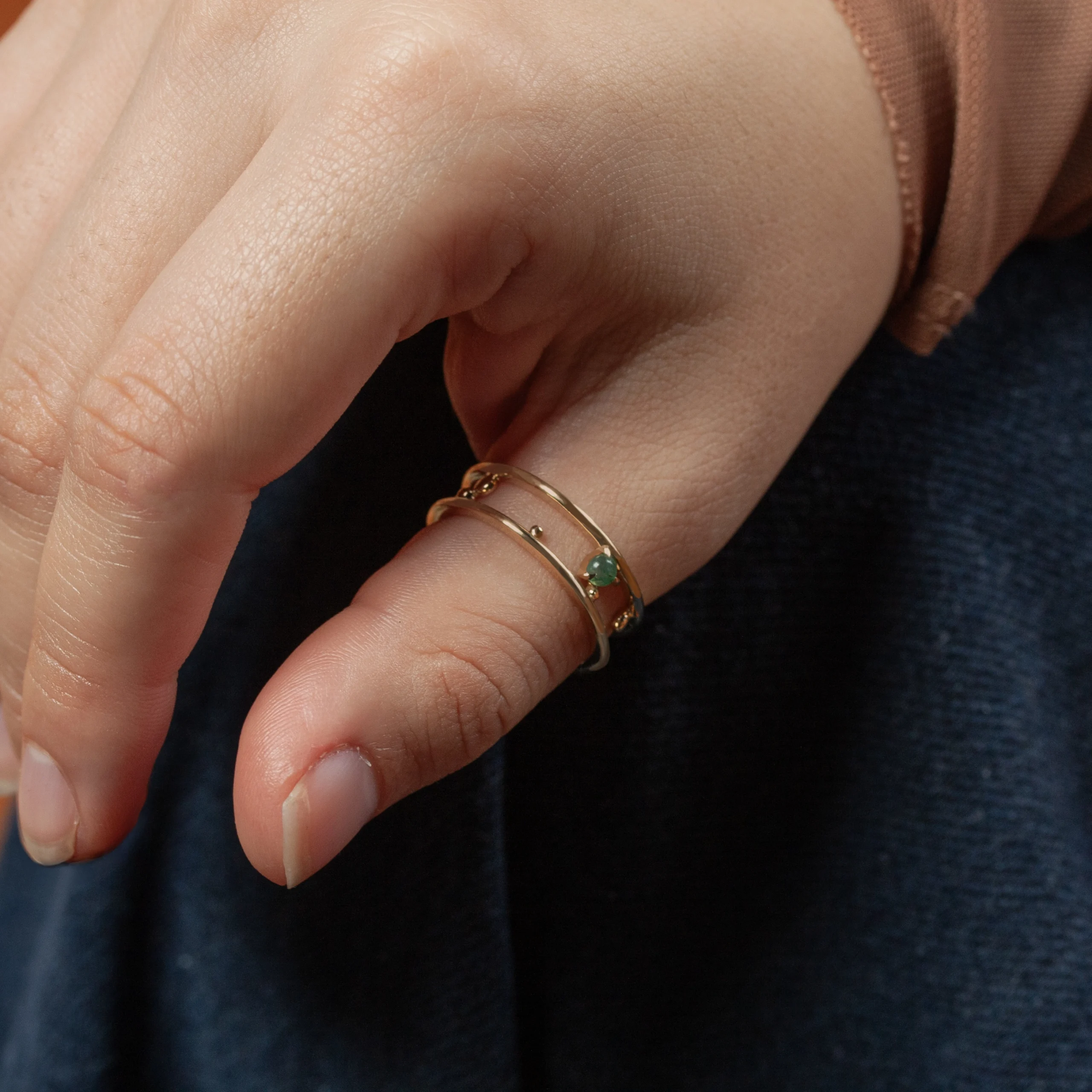 Pinnacle Band by Emily Chelsea Jewelry, a custom-designed ring featuring a 3mm Indian moss agate cabochon, symbolizing milestones and movement forward.
