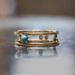 Pinnacle Band by Emily Chelsea Jewelry, a custom-designed ring with a 3mm Arizonian turquoise cabochon, symbolizing milestones and forward movement.