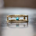 Pinnacle Band by Emily Chelsea Jewelry, a custom ring featuring a 3mm Arizonian turquoise cabochon, symbolizing milestones and progress.