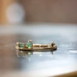 The Renewal Band by Emily Chelsea Jewelry, featuring 3mm Indian moss agate cabochon and 4x2mm baguette, symbolizing milestones and progress.
