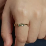 The Renewal Band by Emily Chelsea Jewelry, featuring 3mm Indian moss agate cabochon and 4x2mm baguette, symbolizing milestones and progress.