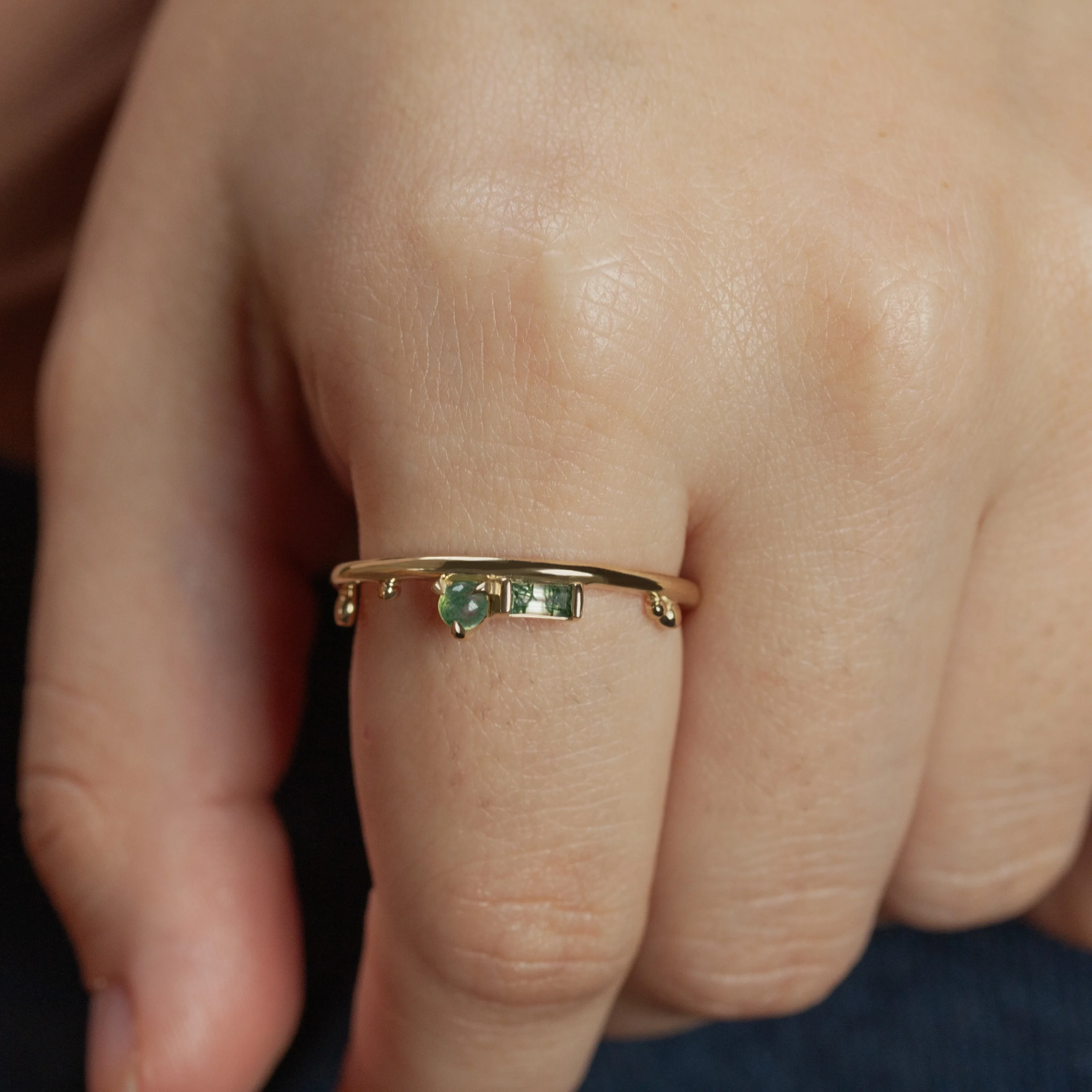 The Renewal Band by Emily Chelsea Jewelry, featuring 3mm Indian moss agate cabochon and 4x2mm baguette, symbolizing milestones and progress.