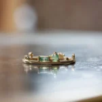 The Renewal Band by Emily Chelsea Jewelry, featuring 3mm Indian moss agate cabochon and 4x2mm baguette, symbolizing milestones and progress.