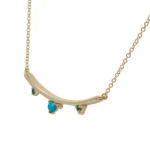 Arc Necklace by Philadelphia’s Emily Chelsea Jewelry, featuring Arizonian turquoise, Nigerian teal tourmaline, and a gracefully curved design.