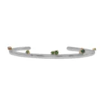Silver Lining Cuff by Philadelphia’s Emily Chelsea Jewelry, featuring Indian moss agate, Nigerian green tourmaline, and a polished finish symbolizing optimism.