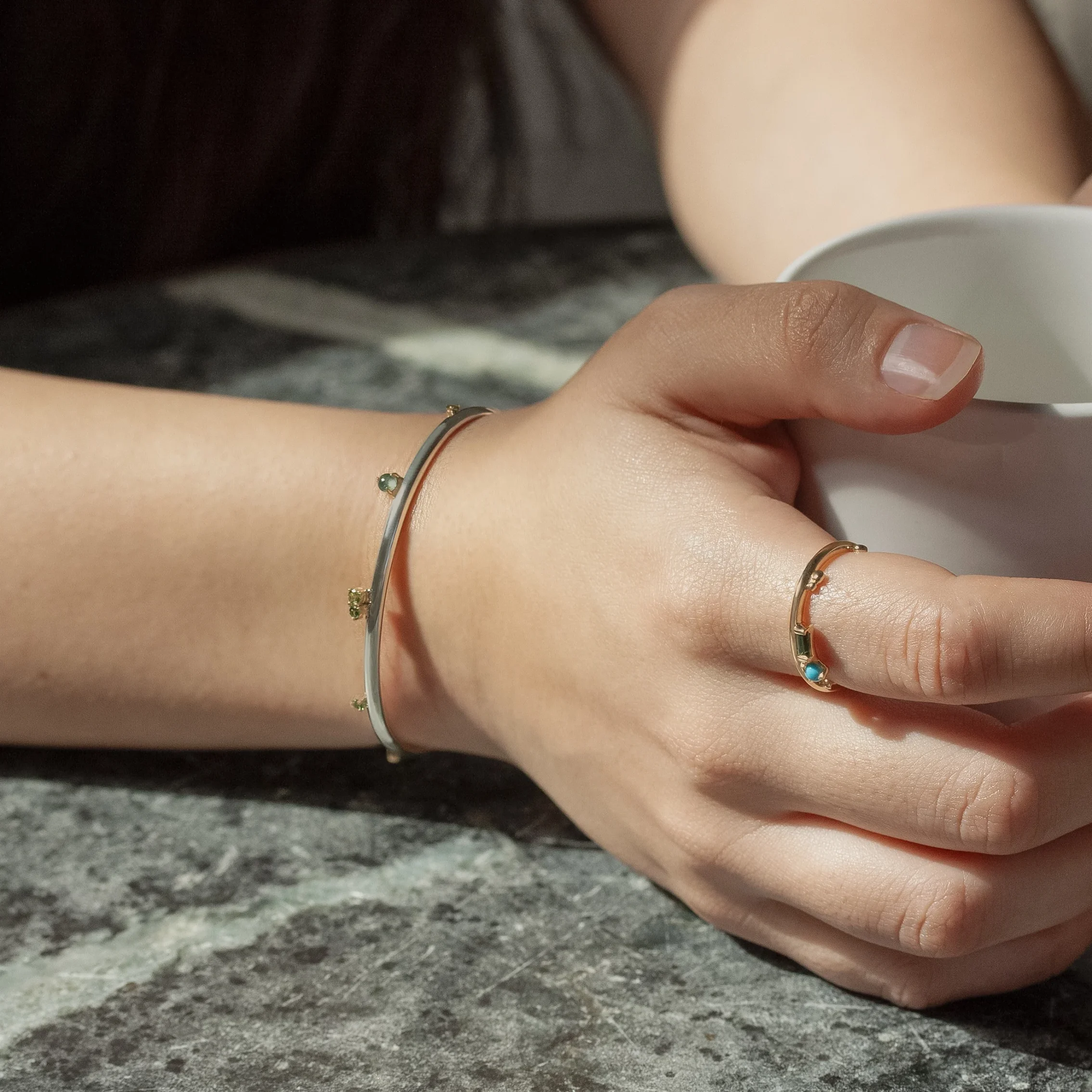 Silver Lining Cuff by Philadelphia’s Emily Chelsea Jewelry, featuring Indian moss agate, Nigerian green tourmaline, and a polished finish symbolizing optimism.