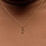 Through It All Necklace by Philadelphia’s Emily Chelsea Jewelry, featuring amethyst, spinel, and a symbolic interrupted bar motif.