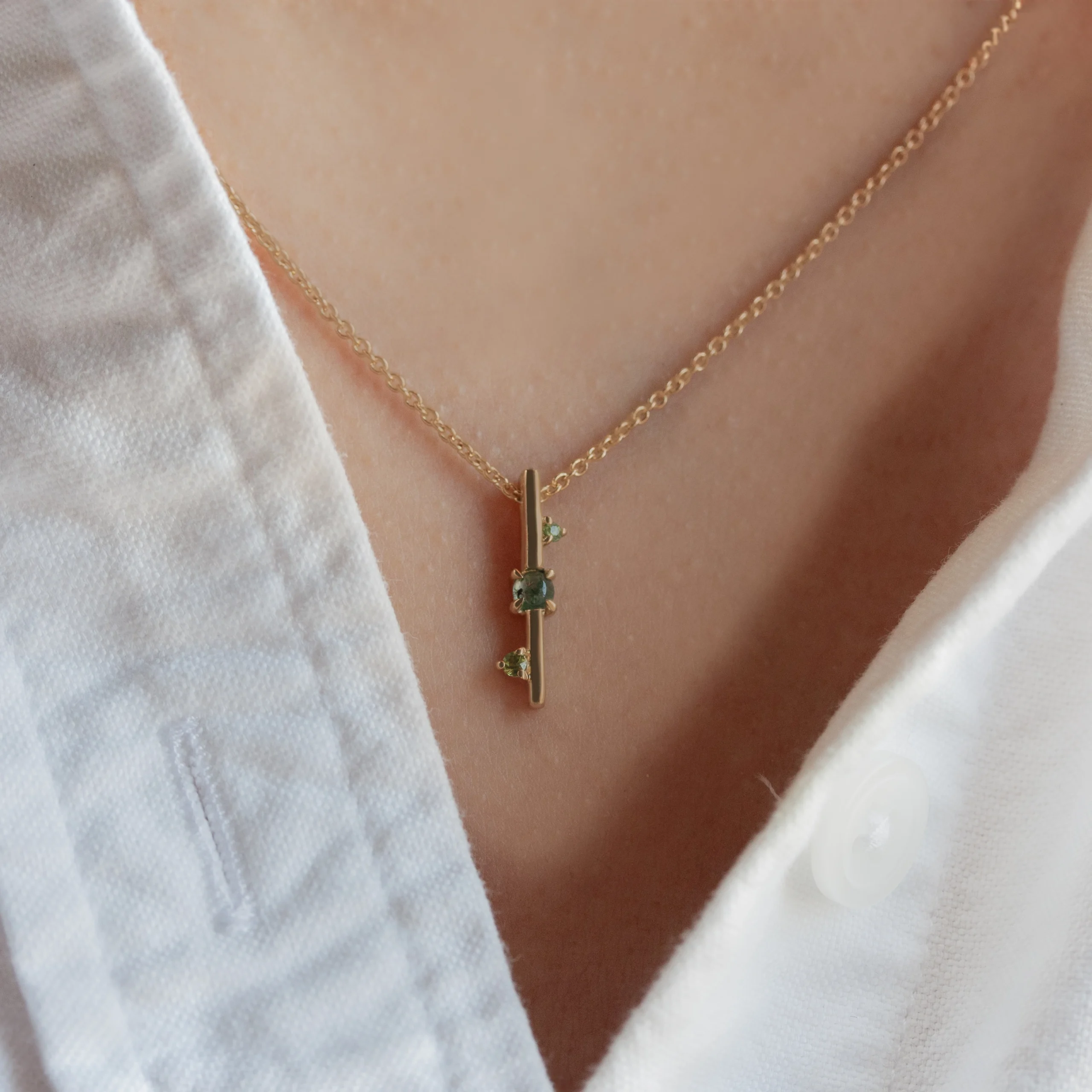 Through It All Necklace by Emily Chelsea Jewelry, a custom design with Indian moss agate, Nigerian green tourmaline, and a symbolic interrupted metal bar motif.