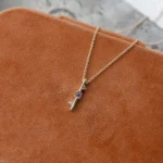 Through It All Necklace by Philadelphia’s Emily Chelsea Jewelry, featuring amethyst, spinel, and a symbolic interrupted bar motif.