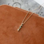 Through It All Necklace by Emily Chelsea Jewelry, a custom design with Indian moss agate, Nigerian green tourmaline, and a symbolic interrupted metal bar motif.