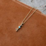 Through It All Necklace by Emily Chelsea Jewelry, a custom design with Arizonian turquoise, Nigerian teal tourmaline, and an interrupted metal bar motif symbolizing resilience.