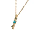 Through It All Necklace by Emily Chelsea Jewelry, a custom design with Arizonian turquoise, Nigerian teal tourmaline, and an interrupted metal bar motif symbolizing resilience.