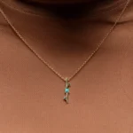 Through It All Necklace by Emily Chelsea Jewelry, a custom design with Arizonian turquoise, Nigerian teal tourmaline, and an interrupted metal bar motif symbolizing resilience.