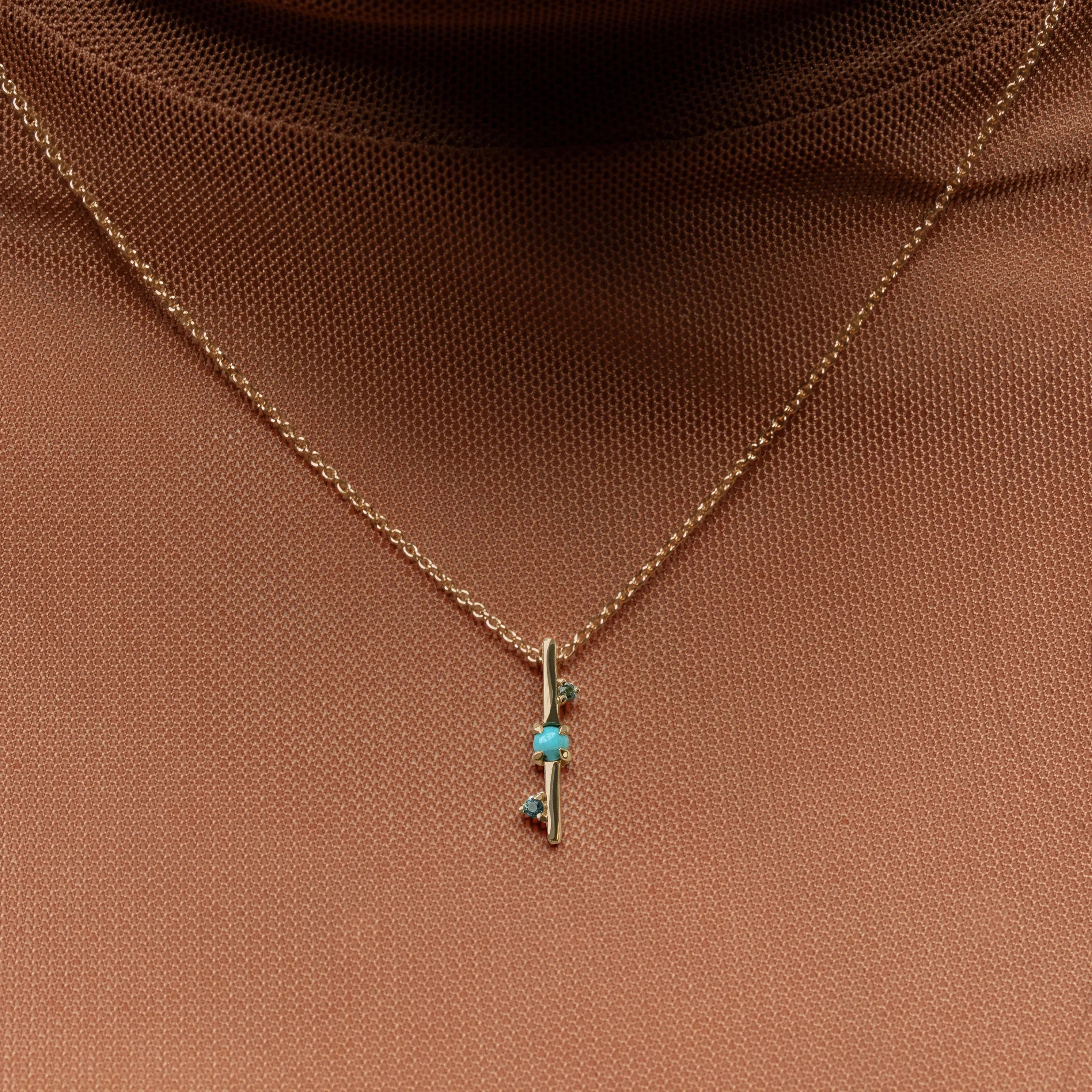 Through It All Necklace by Emily Chelsea Jewelry, a custom design with Arizonian turquoise, Nigerian teal tourmaline, and an interrupted metal bar motif symbolizing resilience.