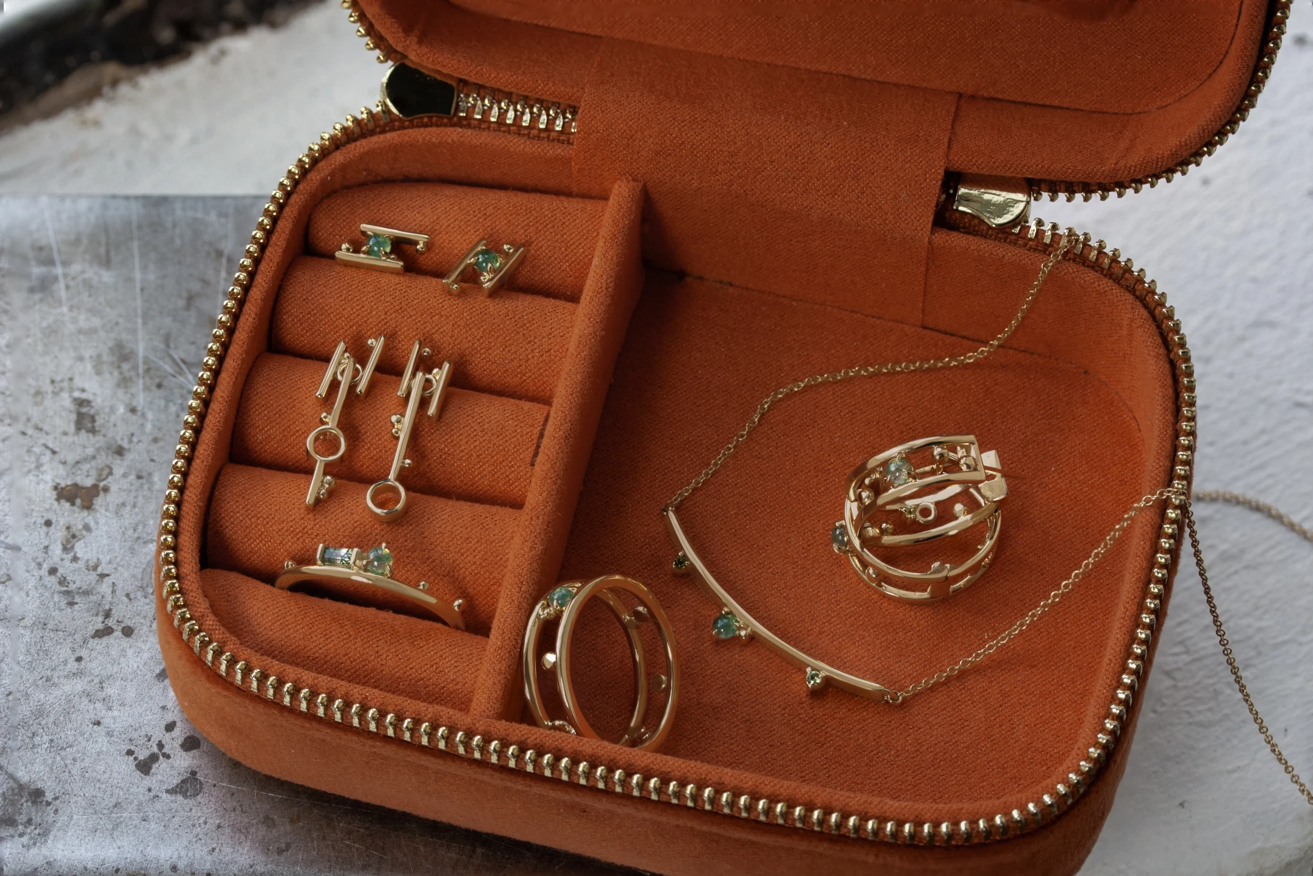 Jewelry box collection featuring gemstones symbolizing milestones and strength, custom-designed by local jeweler Emily Chelsea Jewelry in Philadelphia.