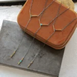 Plunge Necklace by local jeweler, featuring turquoise cabochons and teal tourmaline in a lariat style, set on an adjustable recycled sterling silver chain.